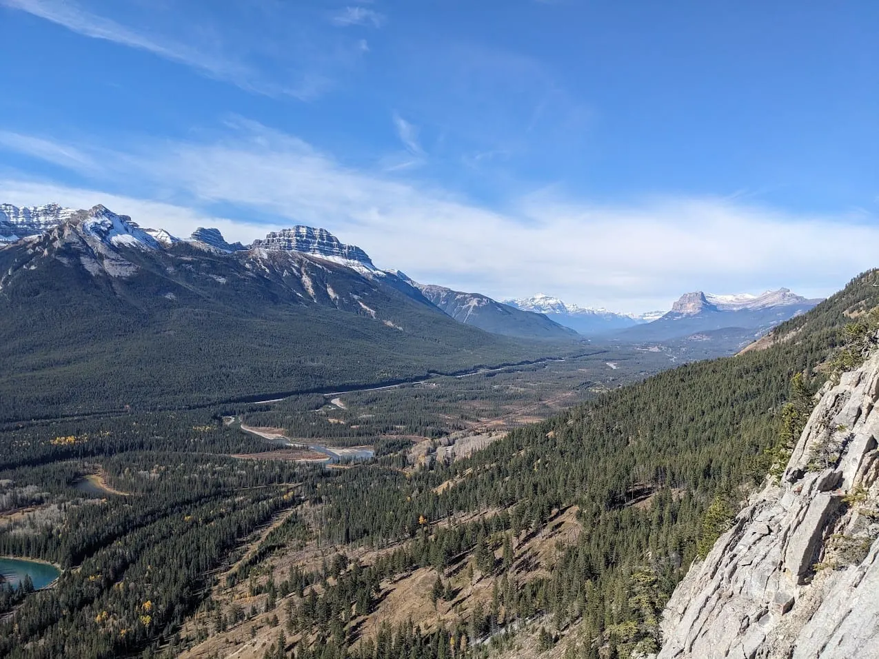 A wide mountain valley under a blue sky